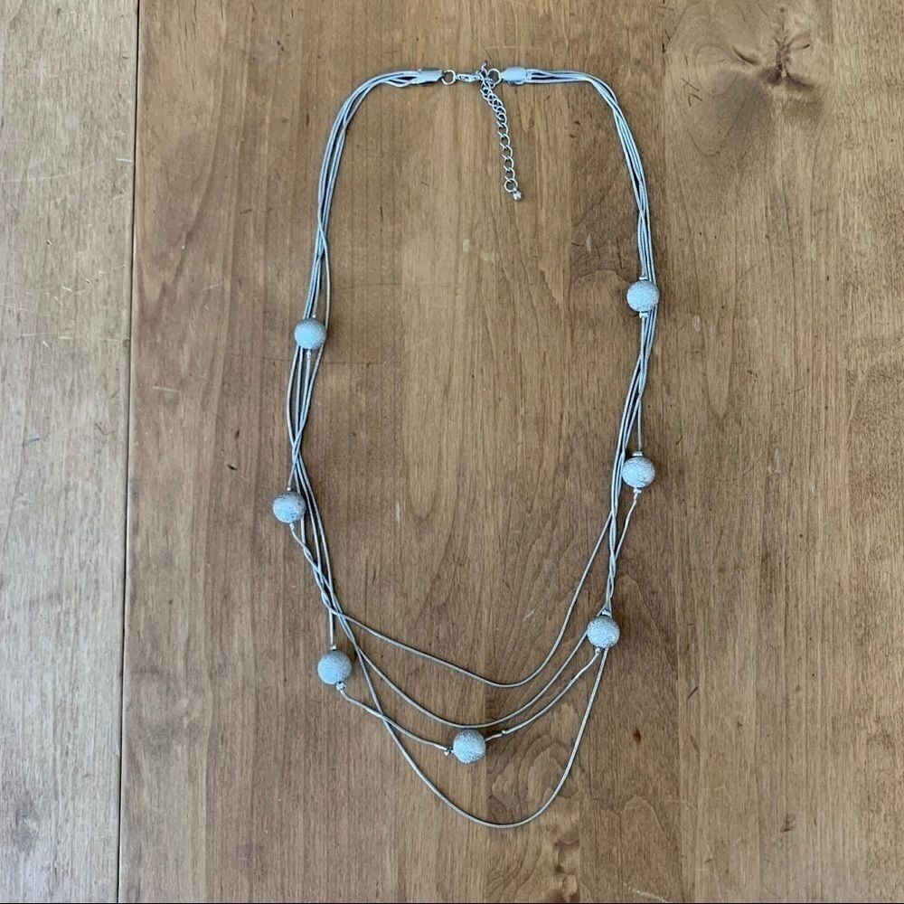 Silver colored necklace with silver beads